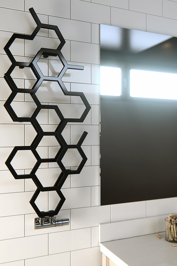 Design-Heizkörper HEX in schwarz an der Wand neben einem Spiegel