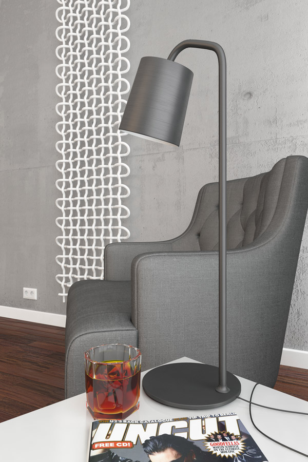 Designheizkörper PLC V weiß arrangiert Beton Wand neben Sessel mit Lampe
